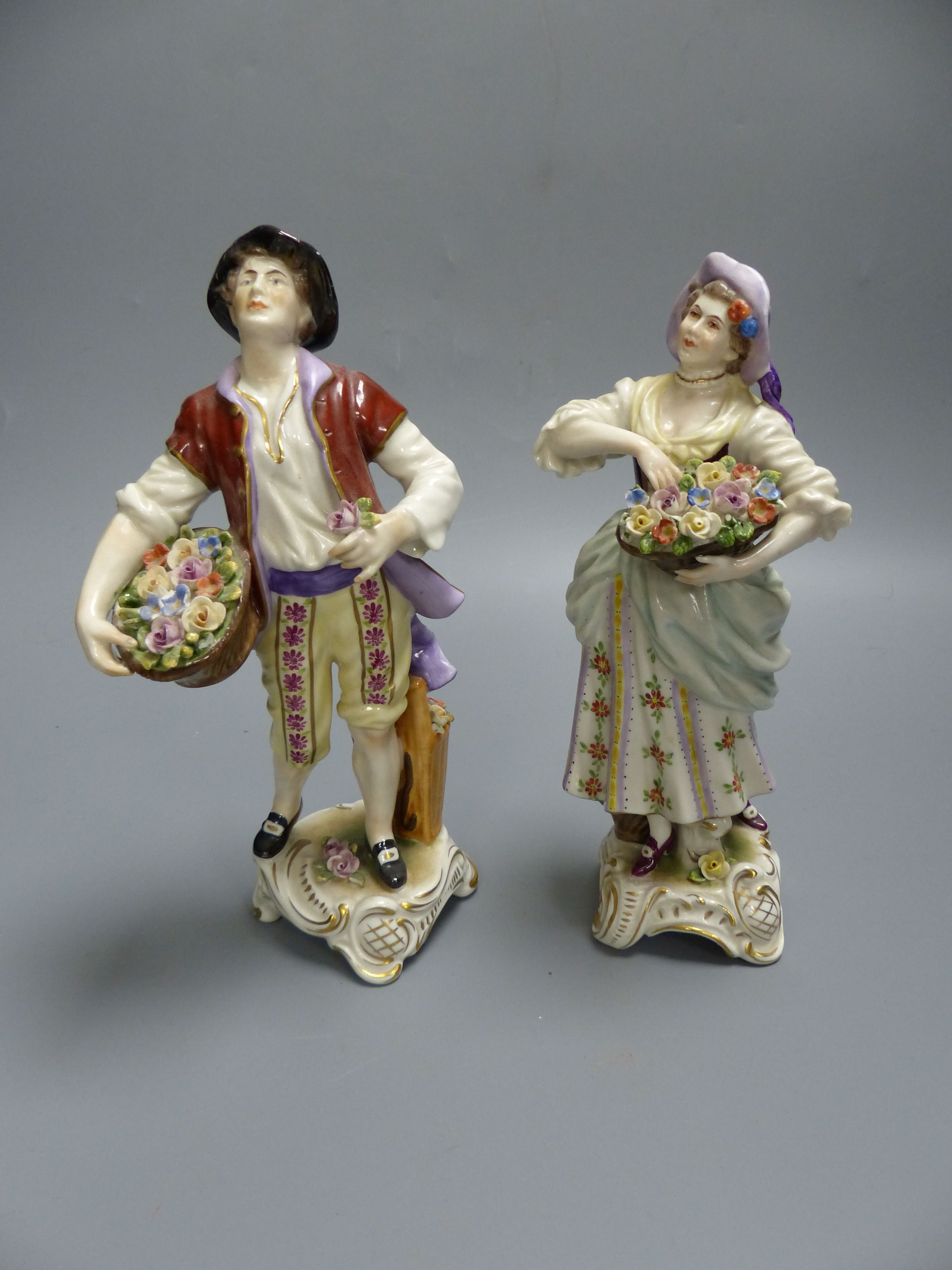 A pair of Rudolf Kammer porcelain figures of flower carriers, height 23cm